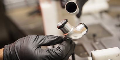 Learn about material bonding. Image of metal pipe bonding with liquid adhesives.
