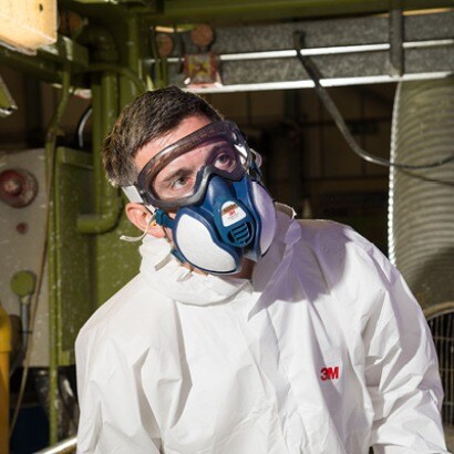 Worker wearing goggles and maintenance free respirator