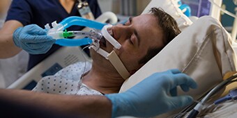 critial care patient being taken care of by medial staff

