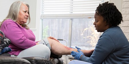 health care provider checking a venous leg ulcer
