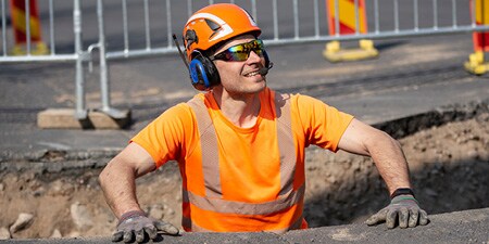 Construction worker wearing Safety helmet with Peltor Communication Headset
