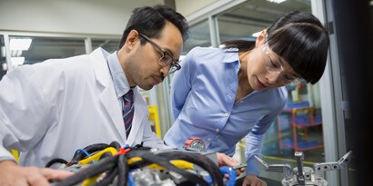 3M Industrial Community. Image of two engineers examining robotics parts in a lab.
