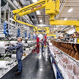 Incorporating adhesives and tapes into the manufacturing process can improve efficiency. Image of manufacturing floor.