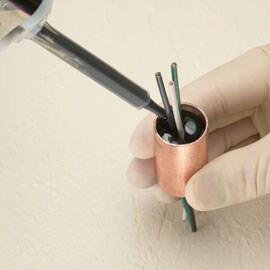 Adhesive flows over and around a component