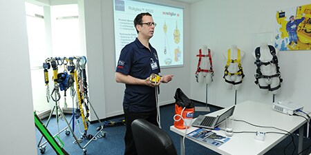 Image showing specialised training instructor demonstrating PPE
