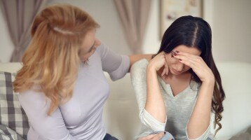 Image of anxious patient having a conversation with a family member
