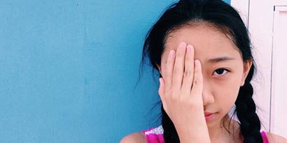 girl covering eye 
